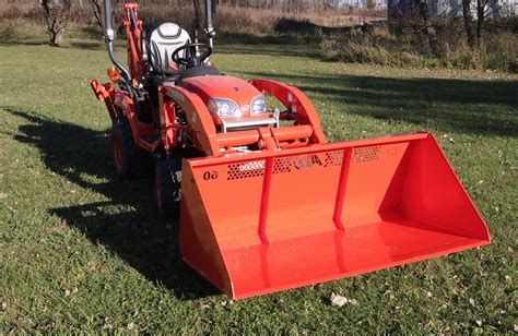 The bucket features a high-back design with cutouts for visibility. . Kubota 60 inch light material bucket